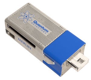 Image of a Merlin detector head which is a metal cuboid with Quantum Detectors logo on top